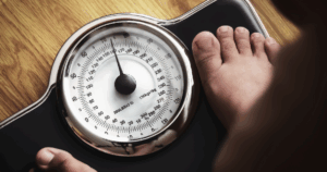 Man standing on scale during hormone therapy-supported weight management at a Las Vegas men’s health clinic