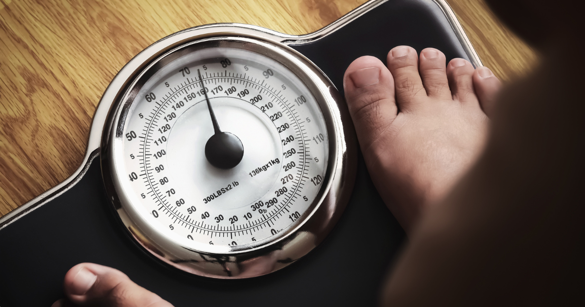 Man standing on scale during hormone therapy-supported weight management at a Las Vegas men’s health clinic